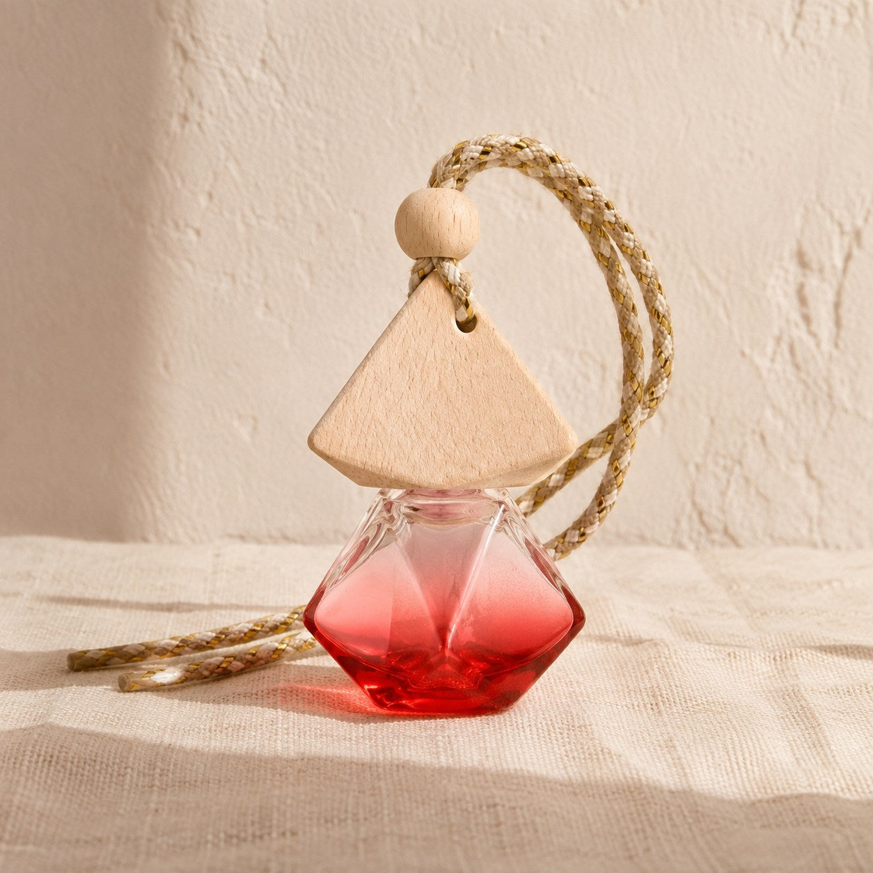 Hanging perfumed car freshener with wooden cap and diamond glass bottle
