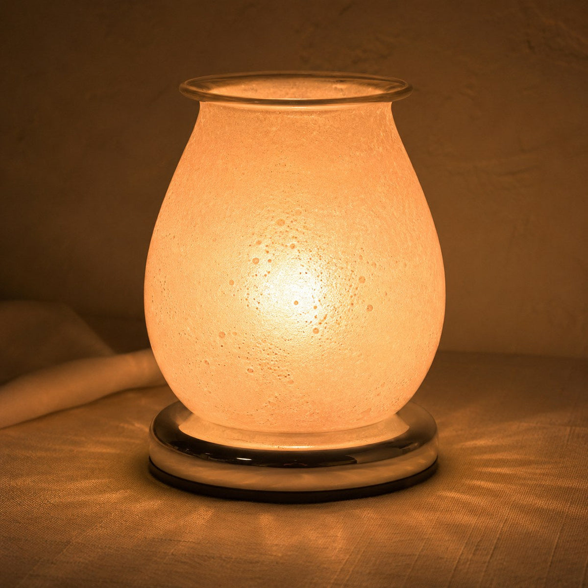 Oval sherbet pearl burner lit at night