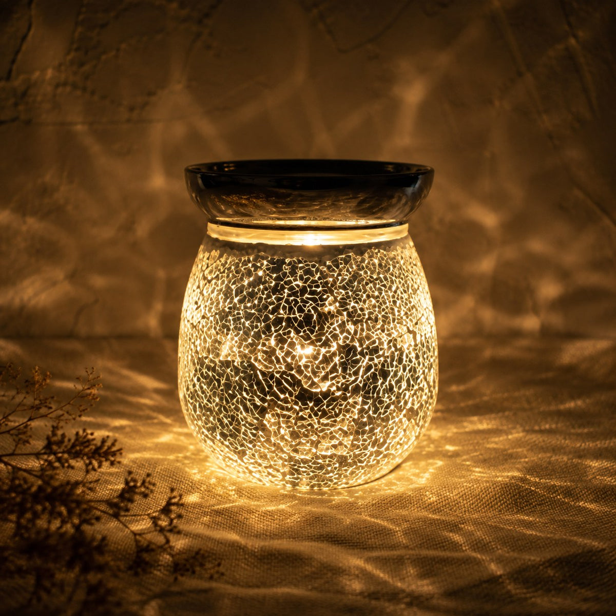 Silver crackle burner lit at night
