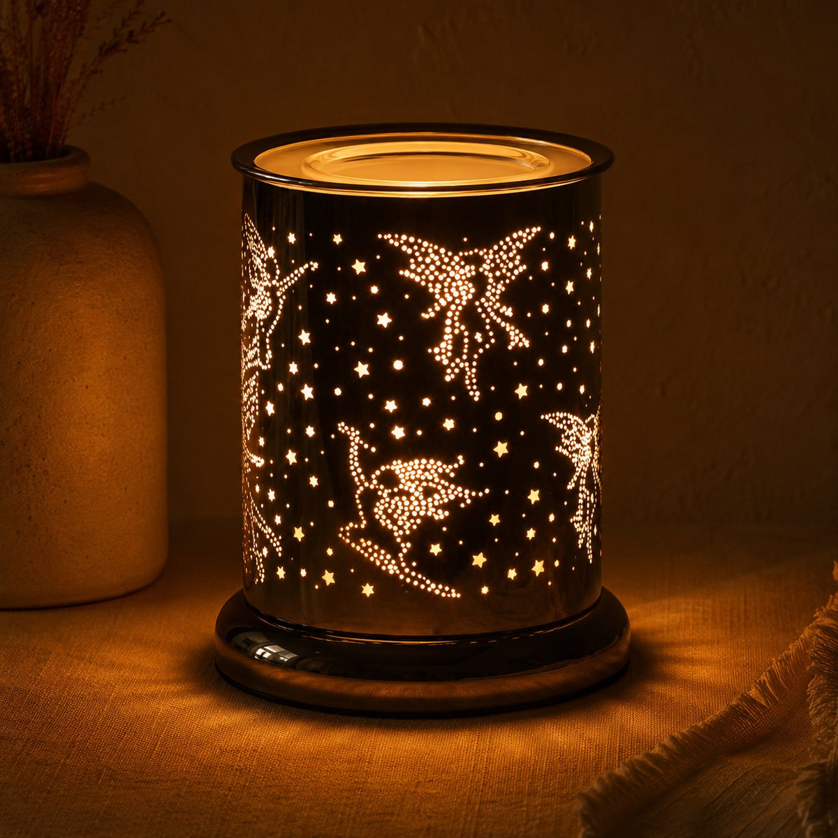 Fairy silhouette burner lit at night