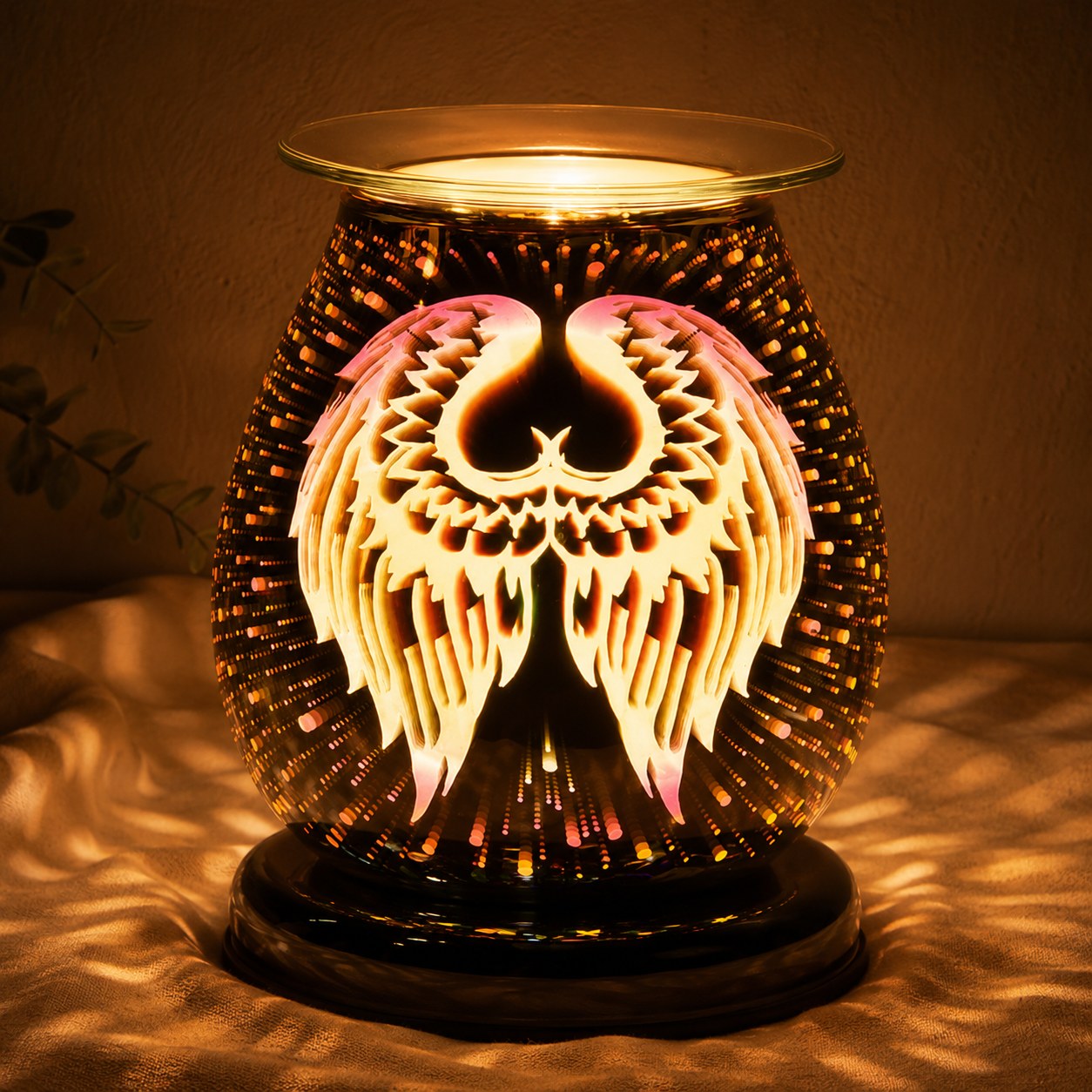 3D angel wings oval burner lit at night
