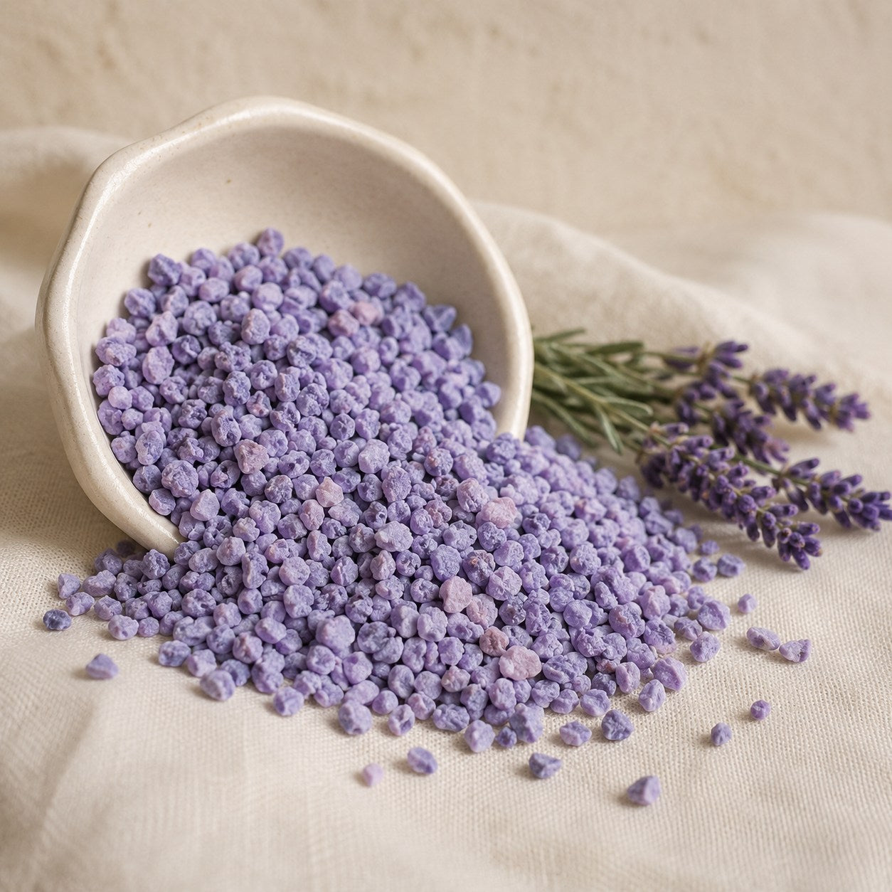 Lavender sleep stones spilling from a cream ceramic dish