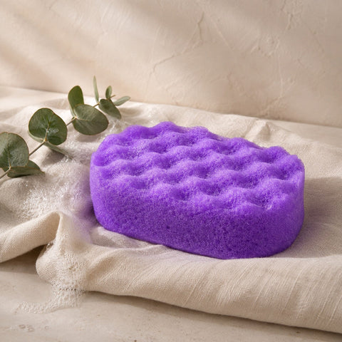 Purple exfoliating soap filled sponge