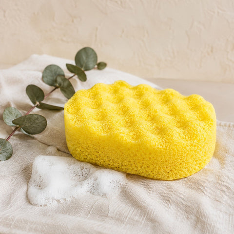 Yellow exfoliating soap filled sponge