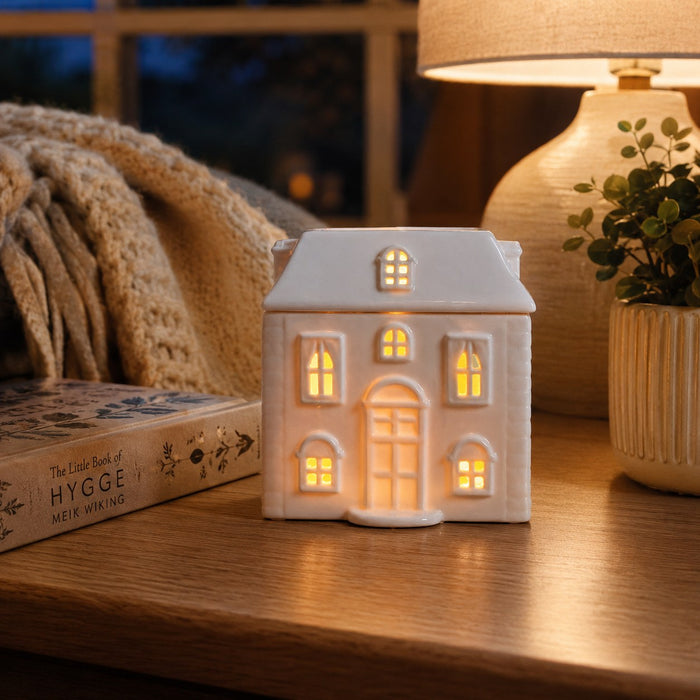 White Ceramic House Burner lit in the dark