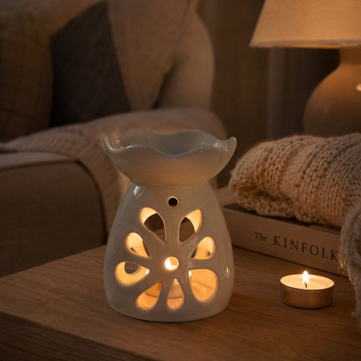 White pastel floral burner in a cosy living room